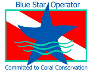 The Blue Star Diving logo. A blue star overlaid on a red flag with a white diagonal stripe. Text above says "Blue Star Operator" and text below says "Committed to Coral Conservation"